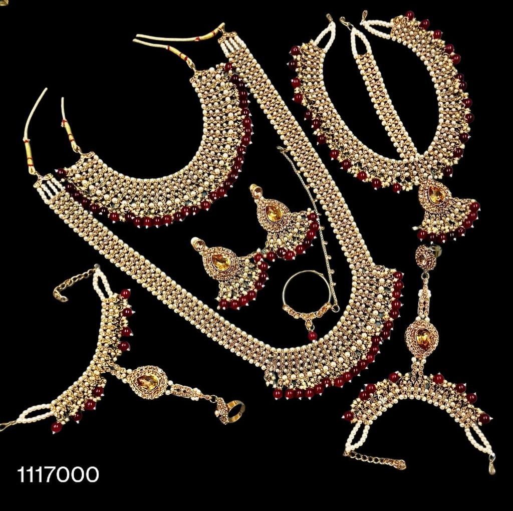 Traditional Indian Bridal Jewelry Set - SA00824PB Elegant gold-toned jewelry set with pearl and stone embellishments